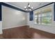 Bright dining room with dark wood floors, chair rail, and large window at 319 Brinkley Cir, Mebane, NC 27302