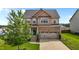 Beautiful two-story home with brick and vinyl siding, attached two-car garage, and well-manicured lawn at 319 Brinkley Cir, Mebane, NC 27302