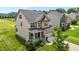 Attractive two-story home featuring brick and vinyl siding, an inviting front porch, and a green lawn at 319 Brinkley Cir, Mebane, NC 27302
