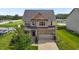 Charming two-story home with brick accents, a two-car garage, and a lush green lawn at 319 Brinkley Cir, Mebane, NC 27302