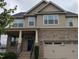 Beautiful two-story brick and shingle home with inviting front porch and well-manicured landscaping at 319 Brinkley Cir, Mebane, NC 27302
