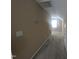 Hallway with carpeted floor and wall-mounted thermostat and light switch leading to another room at 319 Brinkley Cir, Mebane, NC 27302