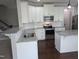 Stylish kitchen features white cabinets, granite countertops, stainless steel appliances, and ample counter space for cooking and entertaining at 319 Brinkley Cir, Mebane, NC 27302
