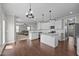 Spacious kitchen featuring white cabinetry, stainless steel appliances, a kitchen island, and new flooring at 319 Brinkley Cir, Mebane, NC 27302