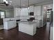 Open concept kitchen with an island, granite countertops, stainless steel appliances, and pendant lighting, great for entertaining at 319 Brinkley Cir, Mebane, NC 27302
