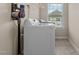 Laundry room with a washing machine, dryer, and a window, all in a clean and organized space at 319 Brinkley Cir, Mebane, NC 27302