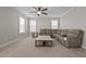 Comfortable living room featuring a ceiling fan, comfortable seating, carpet, and large windows at 319 Brinkley Cir, Mebane, NC 27302