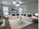 Spacious living room features a plush sectional sofa, a soft rug, and large windows, creating a cozy and inviting atmosphere at 319 Brinkley Cir, Mebane, NC 27302