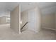 A spacious loft with neutral walls, carpet, and a doorway leading to the attic at 319 Brinkley Cir, Mebane, NC 27302