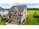 Home exterior featuring a spacious yard, well-kept lawn, two-car garage and dark roof at 319 Brinkley Cir, Mebane, NC 27302