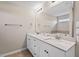Bright bathroom featuring a double sink vanity with quartz countertops and a large mirror at 328 Avery Meadows Dr, Smithfield, NC 27577