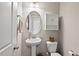 Cozy powder room boasts a pedestal sink, oval mirror, and storage cabinet at 328 Avery Meadows Dr, Smithfield, NC 27577