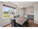 Bright dining room with hardwood floors, a stylish chandelier, and a clear backyard view at 328 Avery Meadows Dr, Smithfield, NC 27577