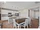 Bright kitchen features white cabinetry, stainless appliances, granite counters, and a dining table at 328 Avery Meadows Dr, Smithfield, NC 27577
