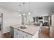 Open concept kitchen with an island featuring granite countertops and a seamless view into living spaces at 328 Avery Meadows Dr, Smithfield, NC 27577