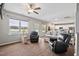 Open-concept living room features a fireplace, cozy seating, and views of the pool at 328 Avery Meadows Dr, Smithfield, NC 27577