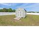 Outdoor shed in the backyard, painted grey with white trim, providing extra storage space at 328 Avery Meadows Dr, Smithfield, NC 27577