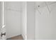 Compact walk-in closet with shelving and hanging rods to optimize space for storage at 328 Avery Meadows Dr, Smithfield, NC 27577