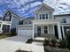 Attractive two-story home with a two-car garage and a welcoming entrance with an accent teal-colored door at 328 Catheys Creek Cir, Wendell, NC 27591