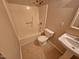Bathroom featuring a tub-shower combo and pedestal sink at 3559 Mill Run, Raleigh, NC 27612