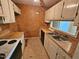 Kitchen with wood countertops, white cabinets, window, and white appliances at 3559 Mill Run, Raleigh, NC 27612