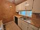 A compact kitchen with white cabinets and a double basin sink at 3559 Mill Run, Raleigh, NC 27612