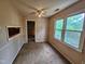 Sunlit living room featuring large windows and a ceiling fan at 3559 Mill Run, Raleigh, NC 27612