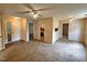Living room featuring a ceiling fan, carpet, access to other rooms at 3559 Mill Run, Raleigh, NC 27612