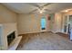 Spacious living room with a white-brick fireplace, ceiling fan, and access to the outdoors via glass doors at 3559 Mill Run, Raleigh, NC 27612