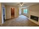Living room featuring a fireplace, ceiling fan, carpet, and access to other rooms at 3559 Mill Run, Raleigh, NC 27612