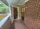 Enclosed porch with brick siding and access door to interior storage at 3559 Mill Run, Raleigh, NC 27612