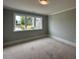 Bright bedroom features a large window offering a picturesque view of the surrounding neighborhood at 3632 Rail Overlook Dr, New Hill, NC 27562