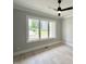 Bright bedroom featuring a large window for natural light and a modern ceiling fan at 3632 Rail Overlook Dr, New Hill, NC 27562