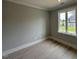 Bright bedroom with hardwood floors, a large window, and light gray walls at 3632 Rail Overlook Dr, New Hill, NC 27562