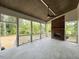 Inviting covered porch with a brick fireplace and screened-in area, perfect for relaxing and entertaining at 3632 Rail Overlook Dr, New Hill, NC 27562