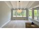 Elegant dining room featuring a modern chandelier, bright windows, and stylish flooring at 3632 Rail Overlook Dr, New Hill, NC 27562