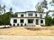 New two-story home featuring a modern design, a welcoming front porch, and manicured landscaping at 3632 Rail Overlook Dr, New Hill, NC 27562