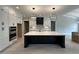 Bright kitchen with modern pendant lighting, a large island, and stainless steel appliances at 3632 Rail Overlook Dr, New Hill, NC 27562