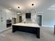 Bright kitchen with modern pendant lighting, a large island, and stainless steel appliances at 3632 Rail Overlook Dr, New Hill, NC 27562