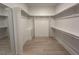Bright walk-in closet with ample storage space, custom shelving, and modern design elements at 3632 Rail Overlook Dr, New Hill, NC 27562
