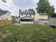 Backyard view showcasing the house, a screened-in porch, and a fire pit at 3825 Old Coach Rd, Raleigh, NC 27616