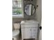 Bathroom with vanity, round mirror, and window at 3825 Old Coach Rd, Raleigh, NC 27616