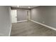 Bedroom with neutral gray walls and wood-look vinyl flooring at 3825 Old Coach Rd, Raleigh, NC 27616