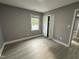 Bright bedroom featuring gray walls, white trim, a window, vinyl floors, and closet at 3825 Old Coach Rd, Raleigh, NC 27616