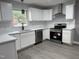 Modern kitchen featuring all-white cabinetry, stainless steel appliances, and contemporary finishes at 3825 Old Coach Rd, Raleigh, NC 27616
