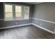 Living room showcasing gray walls, white trim, and vinyl flooring at 3825 Old Coach Rd, Raleigh, NC 27616