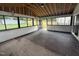 Bright sunroom with dark hardwood floors, white trim, and many windows for natural light at 3825 Old Coach Rd, Raleigh, NC 27616