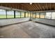 Enclosed sunroom features windows on three sides, wood floors, and exposed rafters at 3825 Old Coach Rd, Raleigh, NC 27616