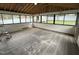 Enclosed sunroom features wall to wall windows, wood floors, and exposed rafters at 3825 Old Coach Rd, Raleigh, NC 27616