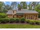 Well-kept backyard with mature trees, screened porch, and a patio perfect for relaxing outdoors at 3919 Wentworth Dr, Durham, NC 27707